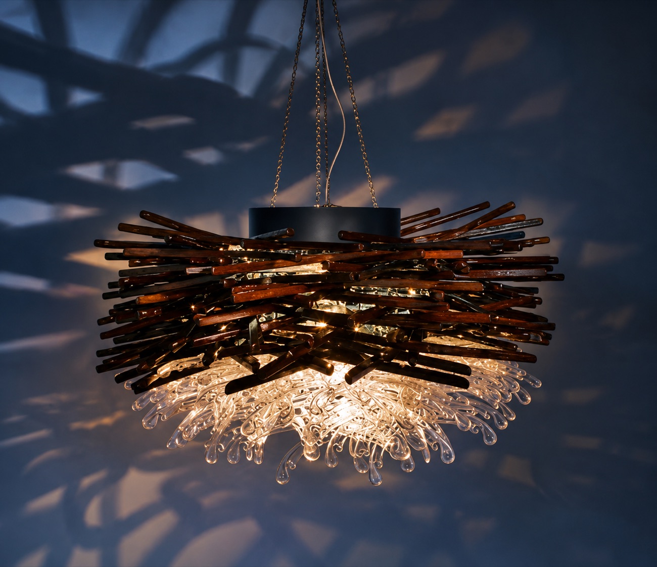 Reclaimed-wood and cast-glass chandelier casting patterned shadows