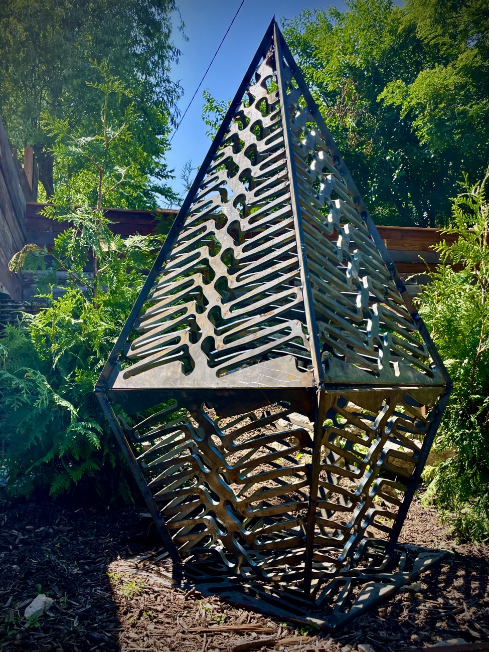 Pyramidal salvaged-metal garden sculpture by Aaron Brand