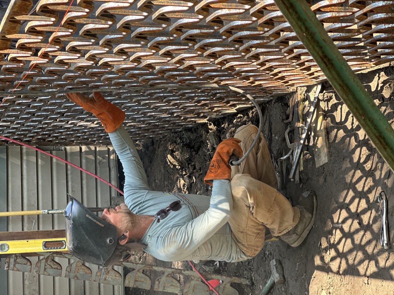Aaron Brand building a laser-cut steel screen by hand